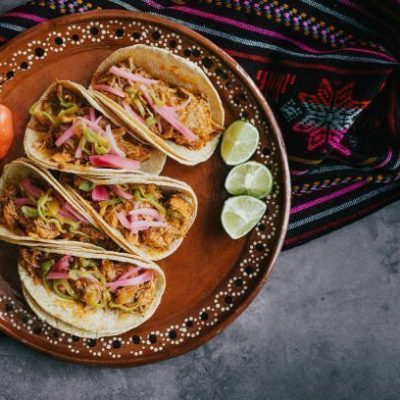 mexican tacos flat lay composition with pork carnitas, cochinita pibil, onion and habanero chili traditional food in Mexico